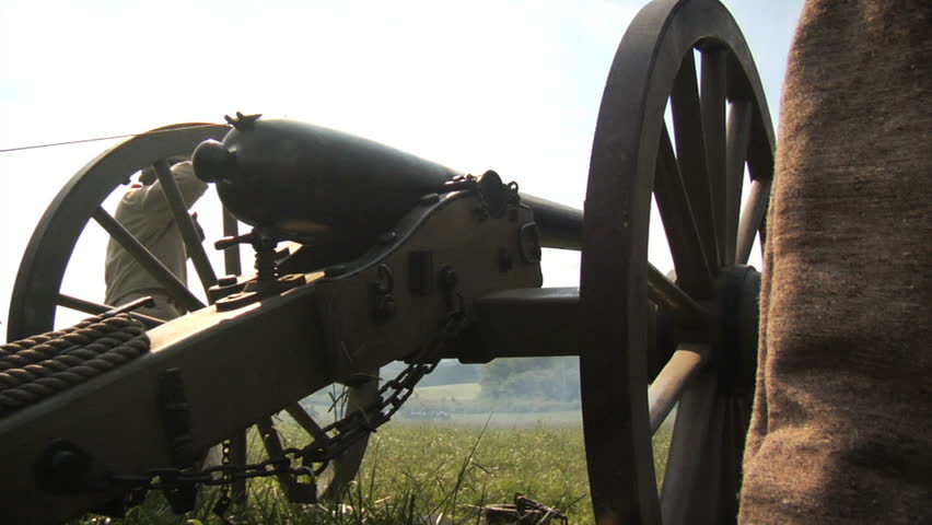 CHICKAMAUGA, GEORGIA - OCTOBER 2008 - large-scale, epic Civil War anniversary reenactment -- in the middle of battle.  Confederate Artillery fires their cannon, camera behind and below with dramatic battle smoke.