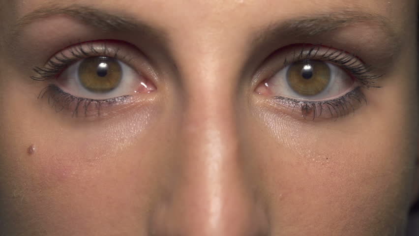 SLOW MOTION: Tear comes out of an eye and streaks down the cheek