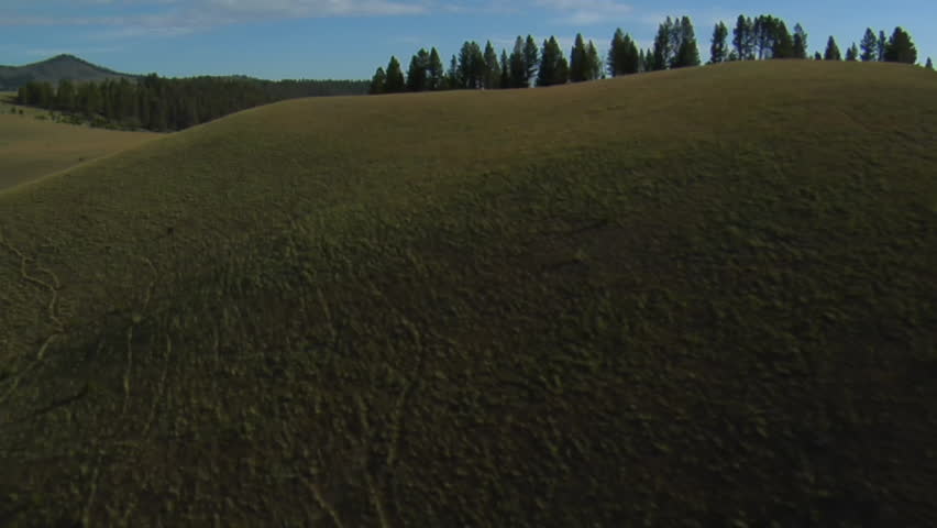 aerial shot of sagebrush pastureland with mountains