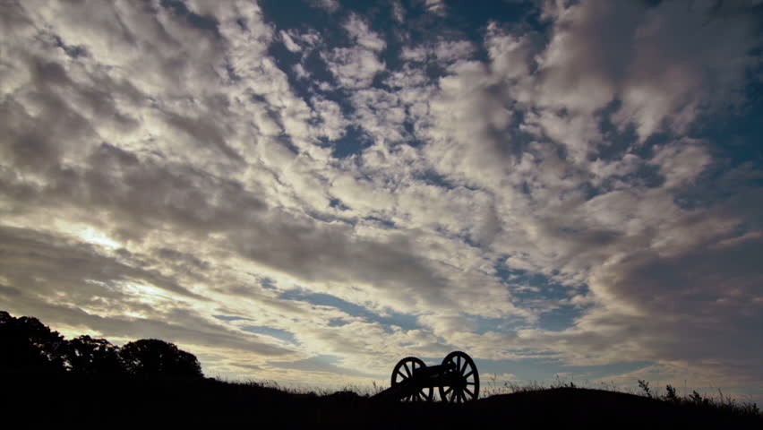 Cloud time-lapse with cannon silhouette at historic battlefield in Yorktown, Virginia, USA