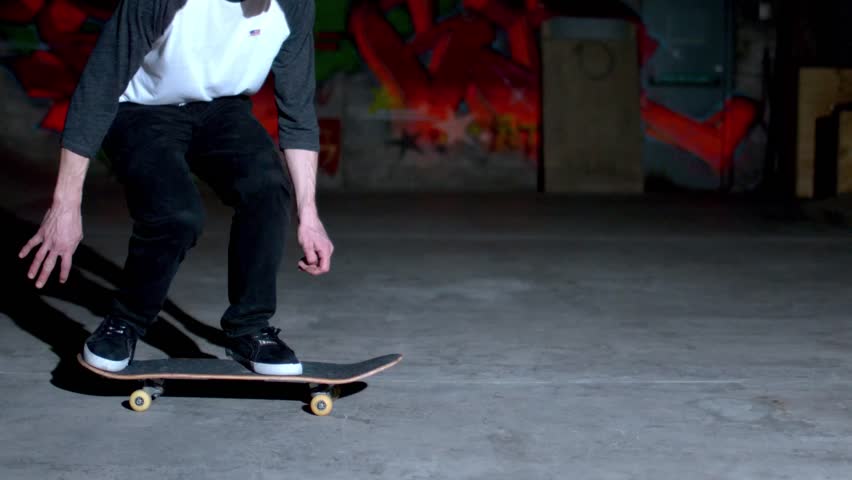 Skater rolling into kickflip trick in slow motion