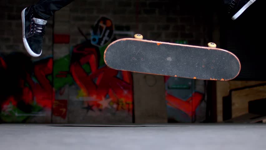 Close up of skater doing 360 flip trick in slow motion
