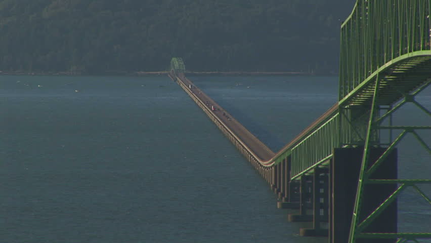 View of Astoria bridge with cars and boat passing, OR 