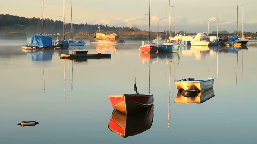 Anchored, Nicomekl River, British Columbia. Boats at anchor in the calm water of the Nicomekl River. Surrey, British Columbia, Canada.
