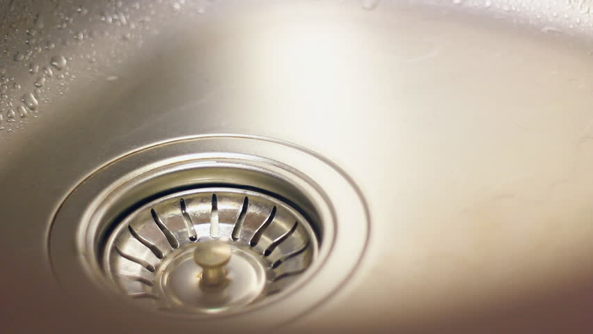 water flows from the tap into the sewer