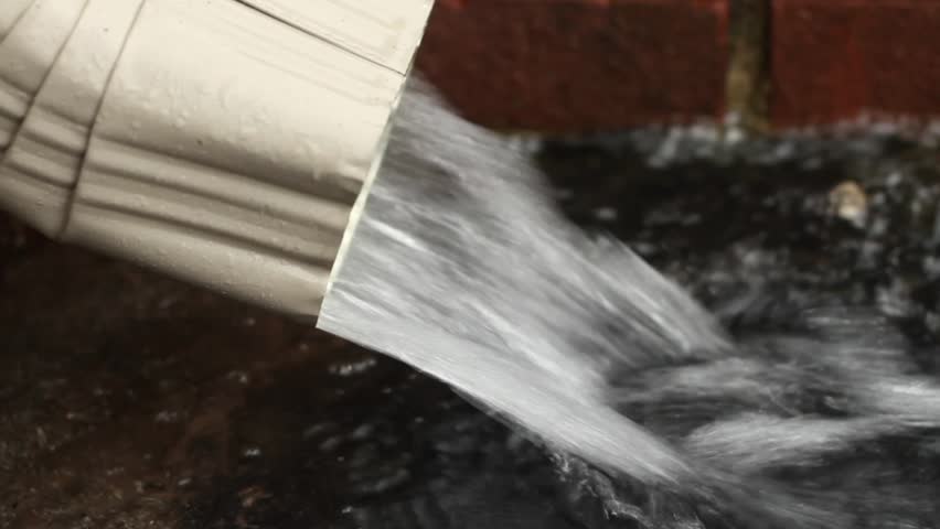 Rainwater draining from from a gutter down spout.