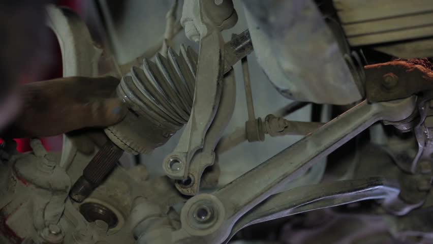Mechanic hands working with car parts dismantling.