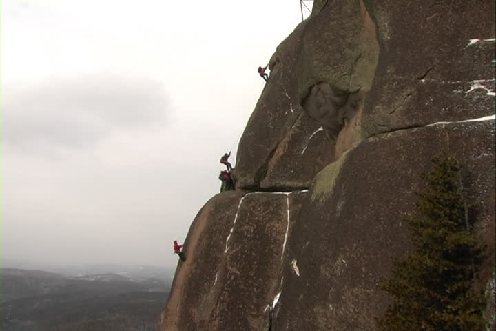 Rock climber zoom in cliff.