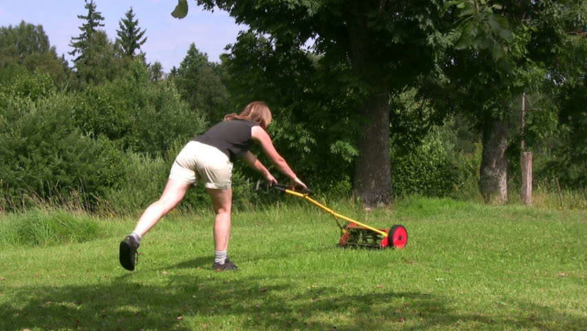 Trimming grass with Hand Lawnmower