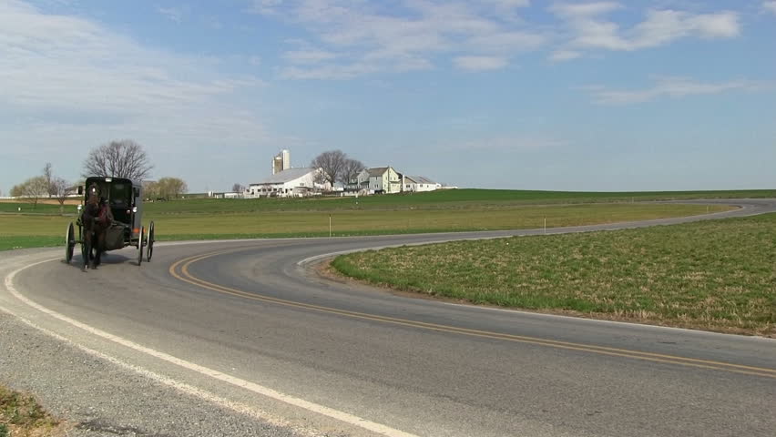 INTERCOURSE,PENNSYLVANIA - APRIL 7 : An Amish family travels with horse and carriage on April 7, 2013 in Intercourse,Lancaster County,Pennsylvania.