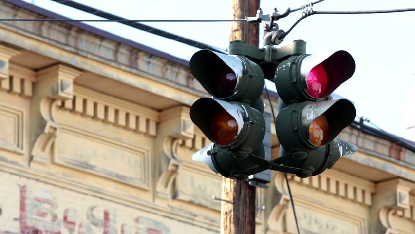 Traffic light flashing warning. Urban city two light sequenced warning stop and go light at major intersection. Old historic building in background.