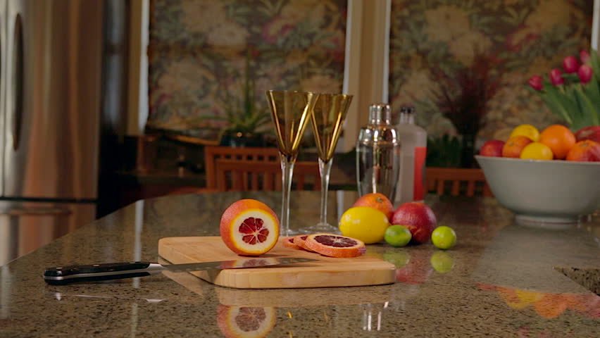 Woman slicing blood oranges for cocktails