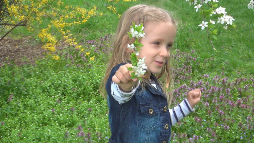 Smiling Child Smelling Spring Flowers, Girl Playing, Laughing in Park, Children