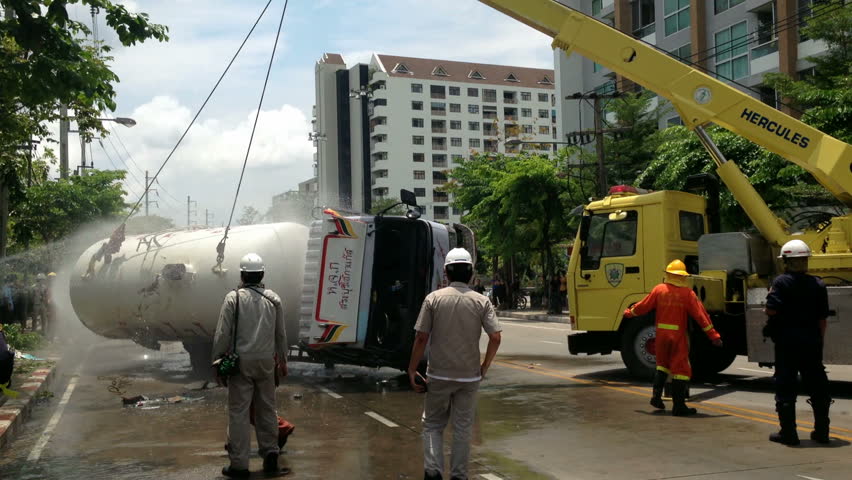 BANGKOK - APRIL 15: A rolled-over gas truck is being craned back on wheel in Bangkok, Thailand, on April 15, 2013. The gas truck crashed after a brake failure