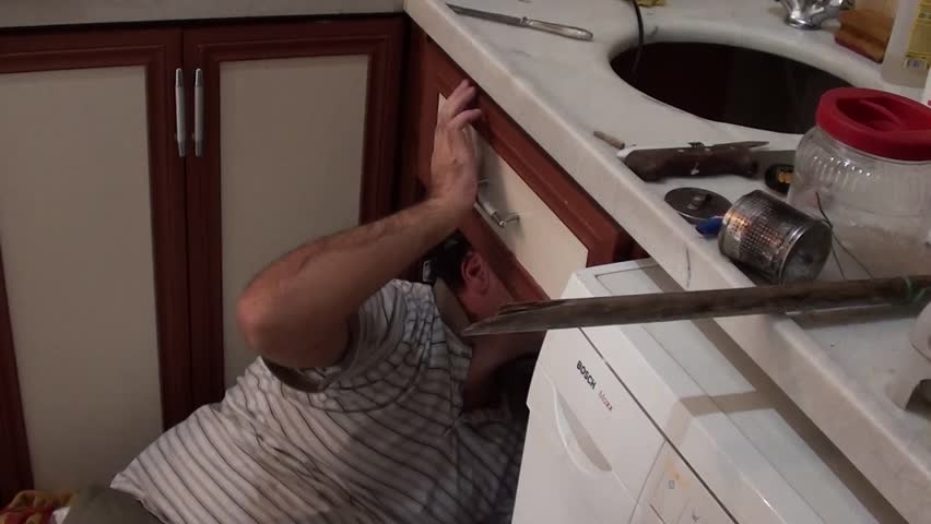 master hand is drilling repairing sink