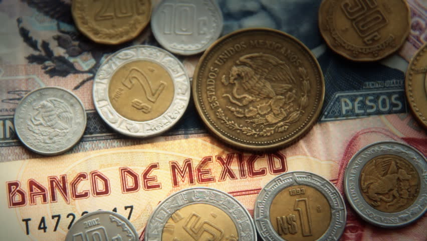 Mexican Pesos 2. Mexican paper money and metal coin currency. Blurred and goes into focus, slowly.