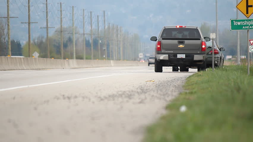 ABBOTSFORD, BRITISH COLUMBIA - APRIL 7: An unmarked police car pulls over a speeding vehicle to issue a ticket near Abbotsford, British Columbia on April 7, 2013. 