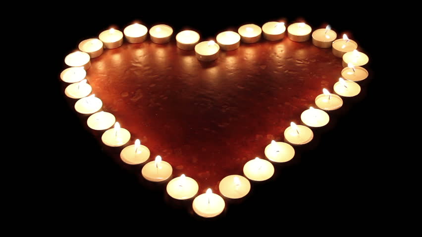 Fiery heart. Candles arranged in a heart shape light up, then go off
