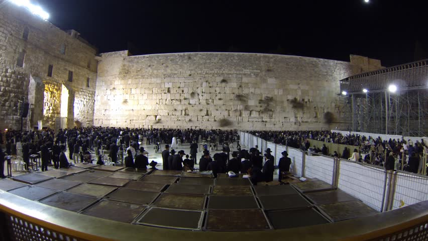 JERUSALEM, ISRAEL -  MARCH 27: Jewish men (L) and women (R) pray in the Western Wall in the night before the Priestly Blessing during the Passover Holiday, March 27 2013 in Jerusalem, Israel.