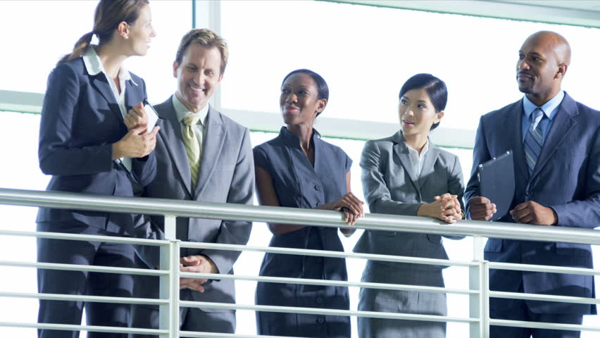 Multi ethnic team meeting on atrium in office building, shot on Red Epic