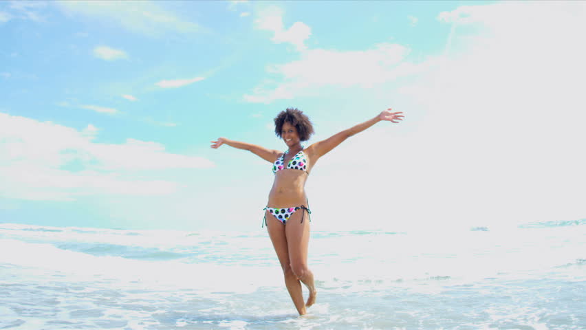 Pretty girl in bikini reveling being alone in ocean by beach vacation resort shot on RED EPIC