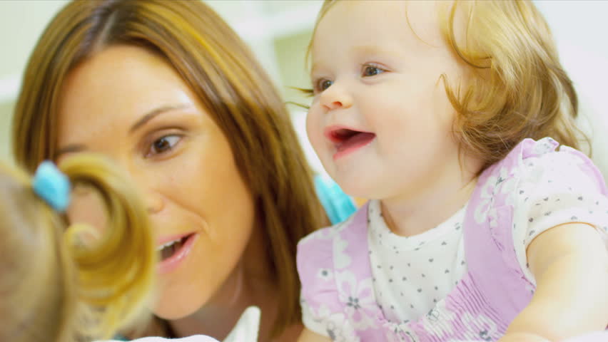 Caucasian parents pre school daughters playing hiding games together home close up shot on RED EPIC