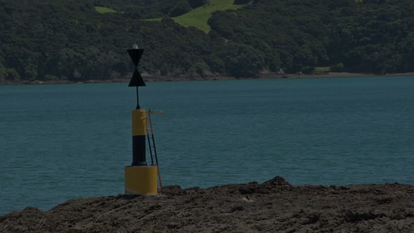 New Zealand. March 2013. A cardinal mark indicates one of the four compass directions, This cardinal mark Indicates that the deepest and safe water to pass on is the west side of the mark 




