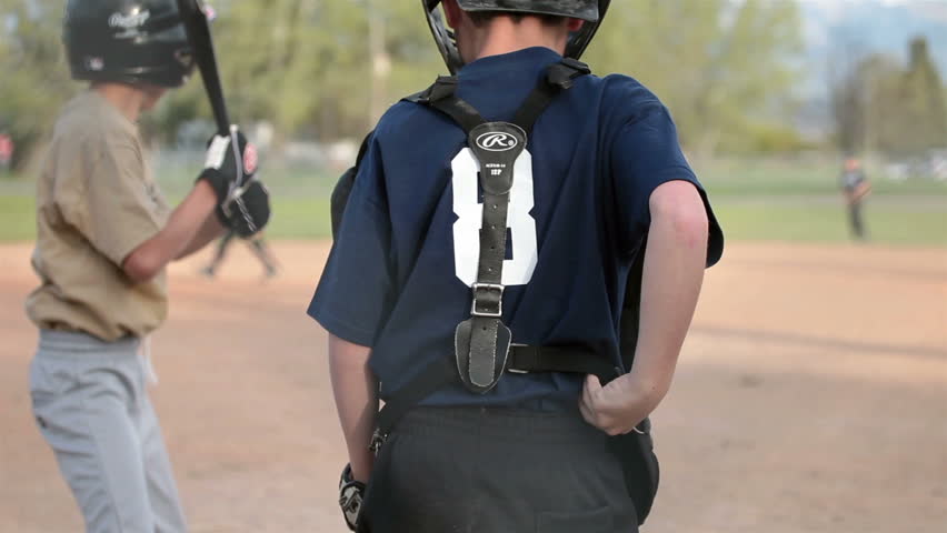 SANPETE, UTAH MAY2012: Baseball major summer recreation in small rural towns. Keeps kids out of trouble. Little league team boy hits ball and runs. Shallow depth of field. Summer fun recreation. 