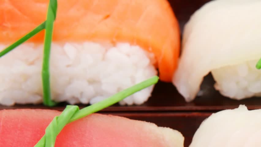 Japanese traditional Cuisine - Roll with Cucumber Cream Cheese with raw Tuna(maguro) and Salmon(sake) inside. dish with sticks 1920x1080 intro motion slow hidef hd