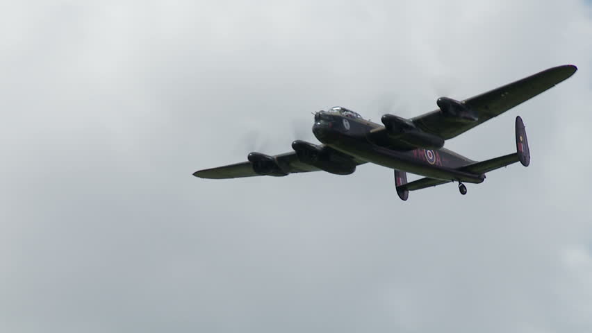 Avro Lancaster bomber plane from World War II flying at normal speed until it gets closer to camera, then clip goes into slow motion.  Originally recorded at 60fps.