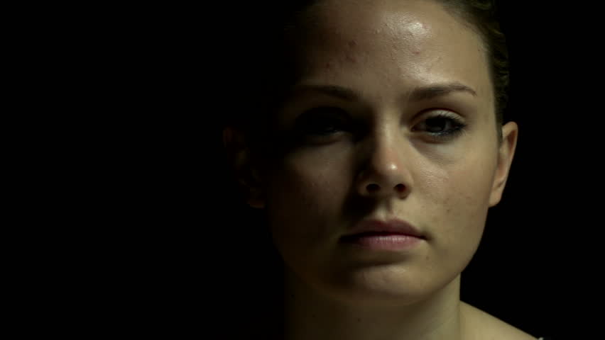 Dolly shot of woman in color. Experimental lighting. 