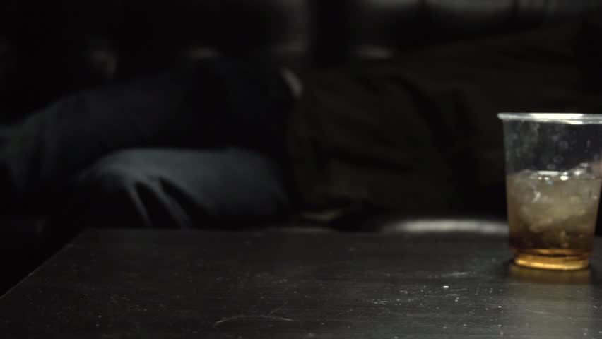 Man falls onto couch after heroin use in slow motion