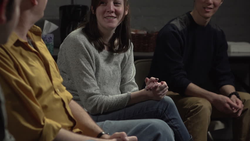 Young girl at support group announces sobriety, members cheers for her