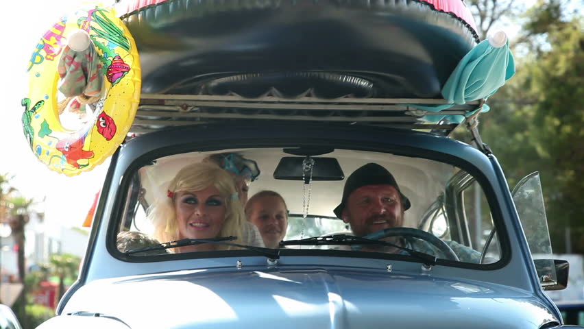 Family having a good time while driving to the beach for summer holiday