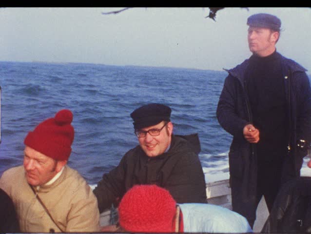 HELGOLAND, GERMANY - CIRCA 1970s: Group of people on boat take trip to Helgoland, Germany circa 1970s. Vintage 8mm film.