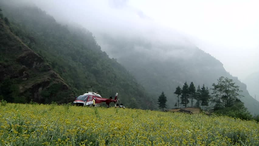 A helicopter waiting in a Sherpa's flower garden on the way to Lukla Airport, near the base of Mt. Everest. 