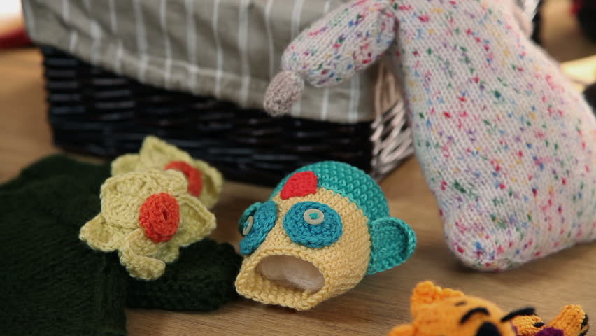 Left to right pan shot over table with knitting products