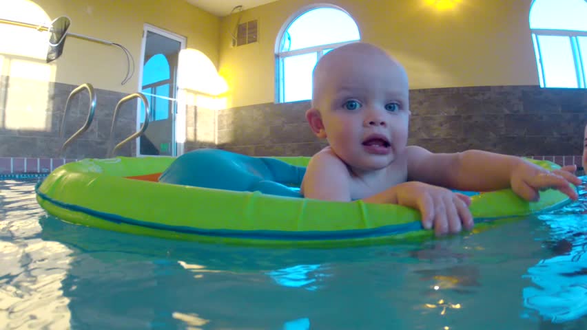 Underwater shot of a cute little baby boy at the swimming pool with his family.