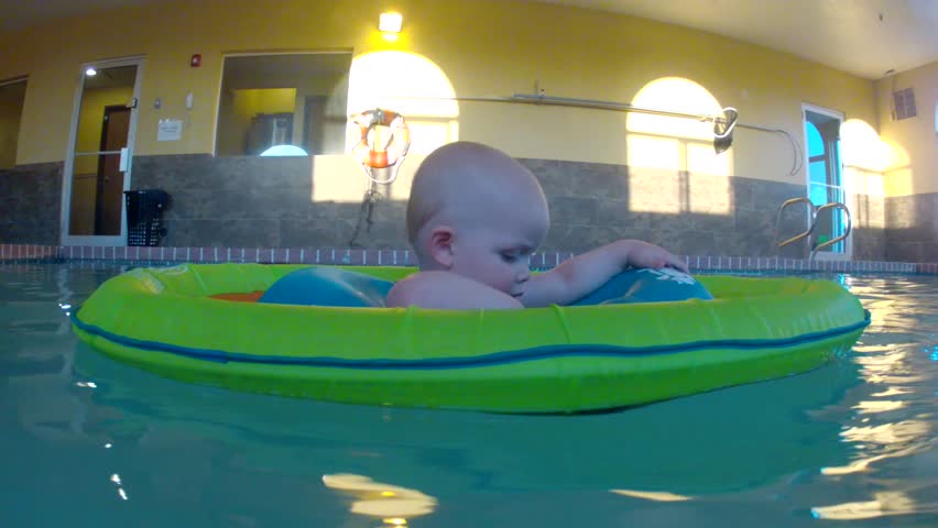 Underwater shot of a cute little baby boy at the swimming pool with his family.