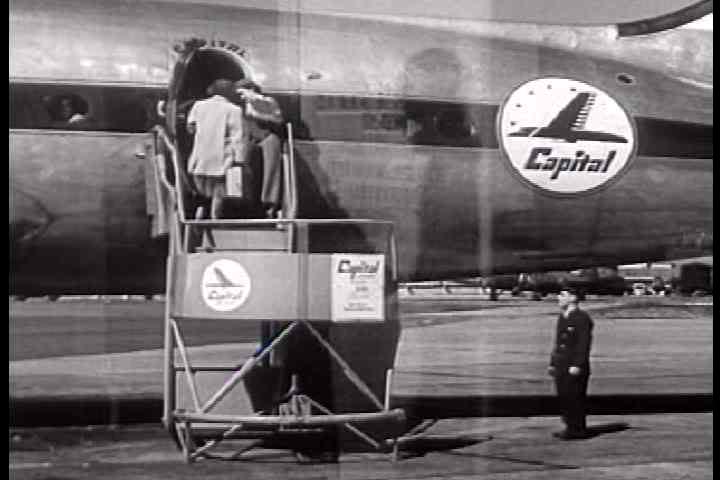 1950s - A couple boards a modern airplane in 1950 which taxis away and is seen in flight.