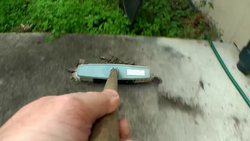 sweeping up using a broom pov