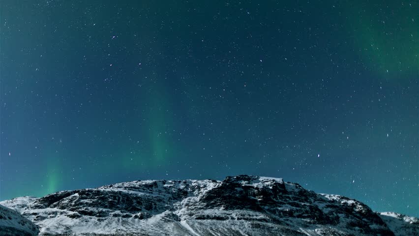 Northern lights (Aurora Borealis) timelapse above a mountain in Norway