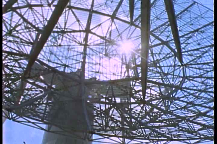 1960s - A satellite dish monitors space communication.