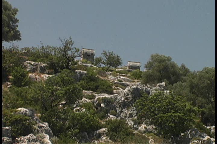 Ancient Lycian necropolis with stone carved sarcophagi atop of rocky mountain, Turkey