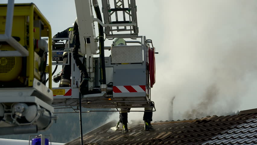SouthTyrol, ITALY - CIRCA 2012: Fire brigade extinguish fire, garden house burns.