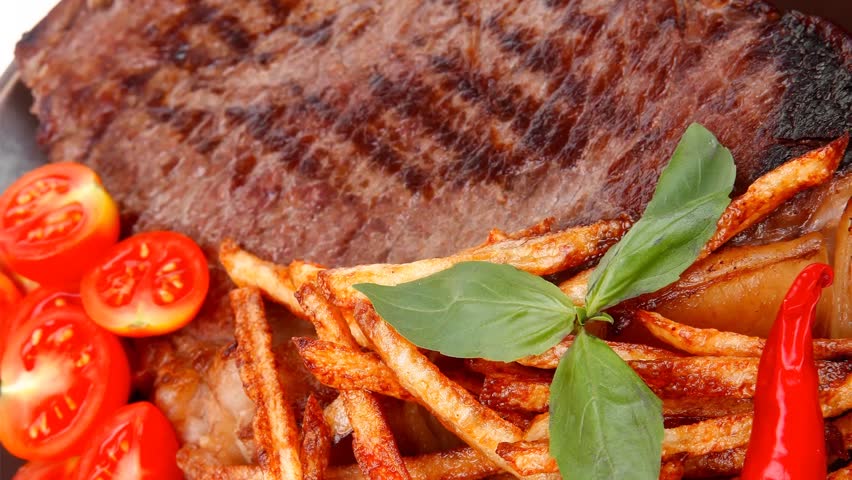 main course : grill beef steak with potato chips and fresh cherry tomato red hot chili peppers on plate 1920x1080 intro motion slow hidef hd