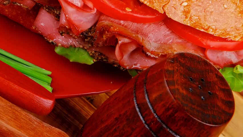 french sandwich : fresh white baguette with chicken smoked sausage on red ceramic plate over wooden table 1920x1080 intro motion slow hidef hd