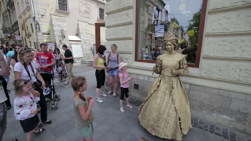 LVIV, UKRAINE - MAY 9: Children are photographed with a living statue. MAY 9 2013 Lviv, Ukraine.