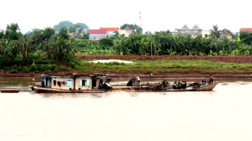 sand dredgers in the riverbed