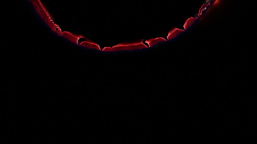 paper glows in an arc from the top downwards against black background